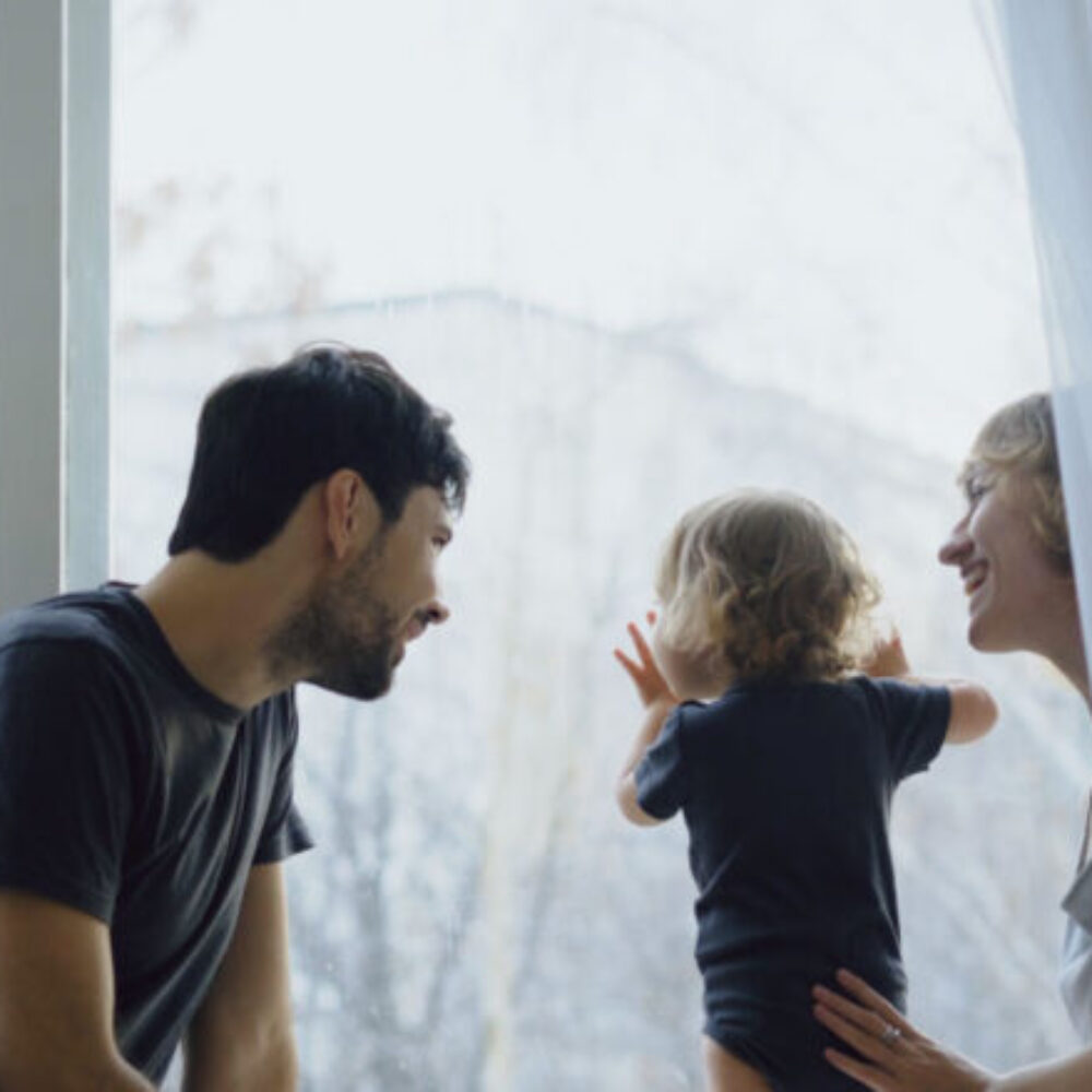 Parents playing with their kid at home